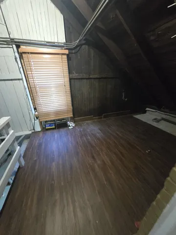 a room with a wooden floor and a window