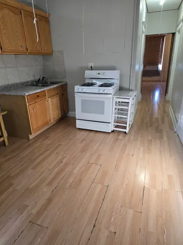a kitchen with wooden floors and a stove