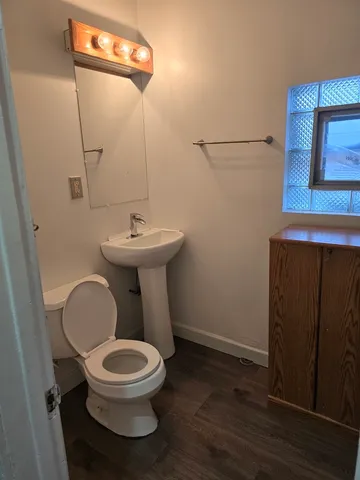 a bathroom with a toilet a sink and a mirror