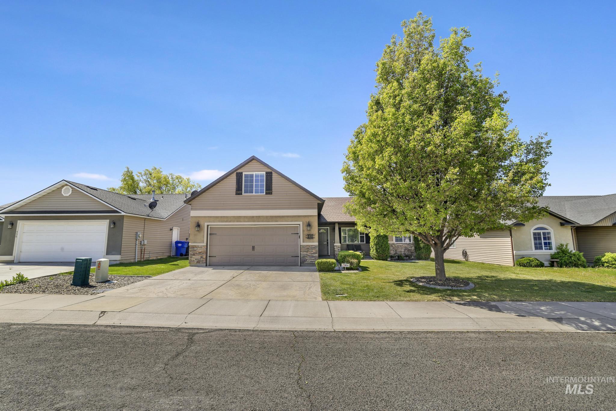 446 Noble Street Twin Falls, ID 83301 - Photo 29 of 42 Front exterior featuring a two-car garage, stone façade accents, and a dormer window