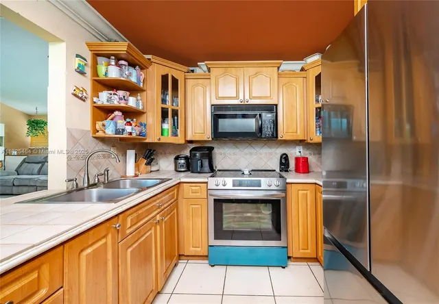 a kitchen with stainless steel appliances granite countertop a sink and cabinets