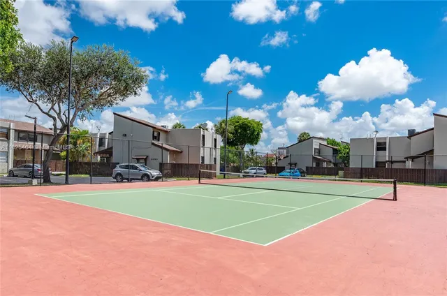 a view of a backyard with wooden fence