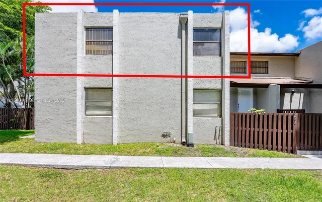 a bird view of a house with a yard and plants