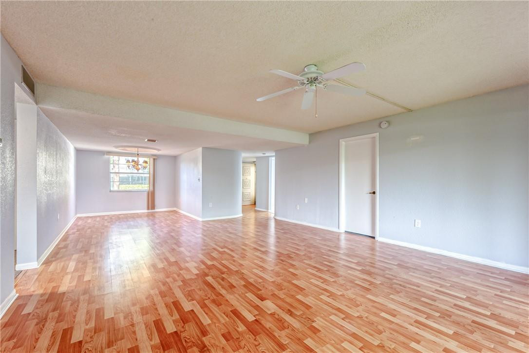3900 Inverrary Boulevard, Unit E2 Lauderhill, FL 33319 - Photo 11 of 45 a view of an empty room with window and wooden floor
