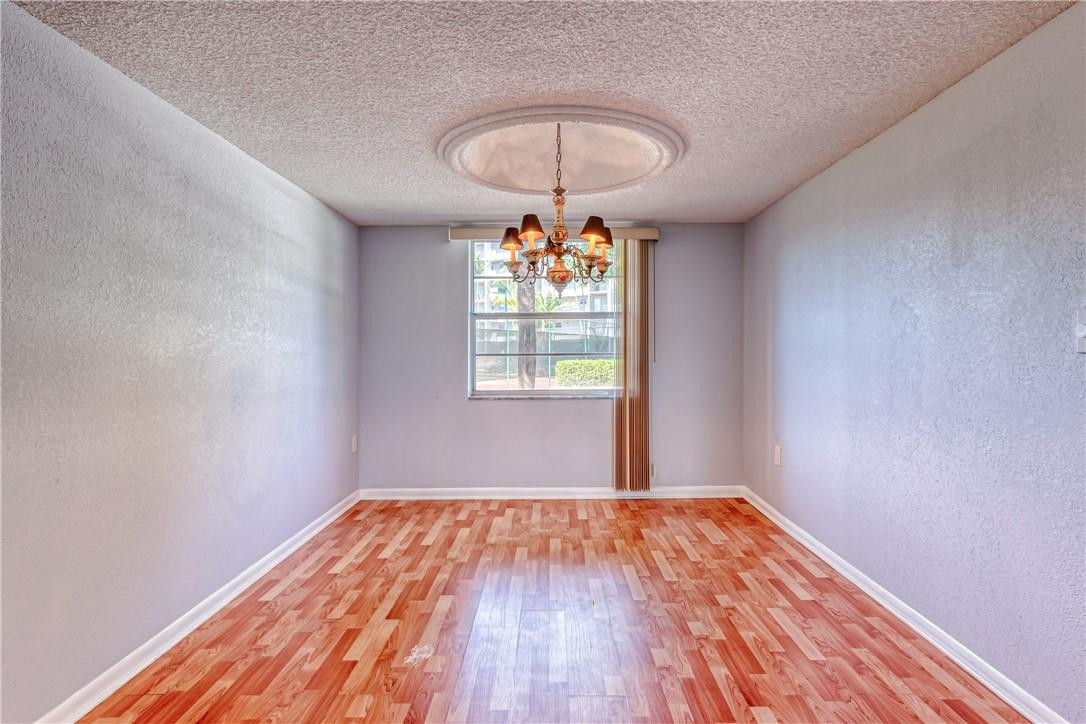 3900 Inverrary Boulevard, Unit E2 Lauderhill, FL 33319 - Photo 12 of 45 a view of empty room with wooden floor and fan