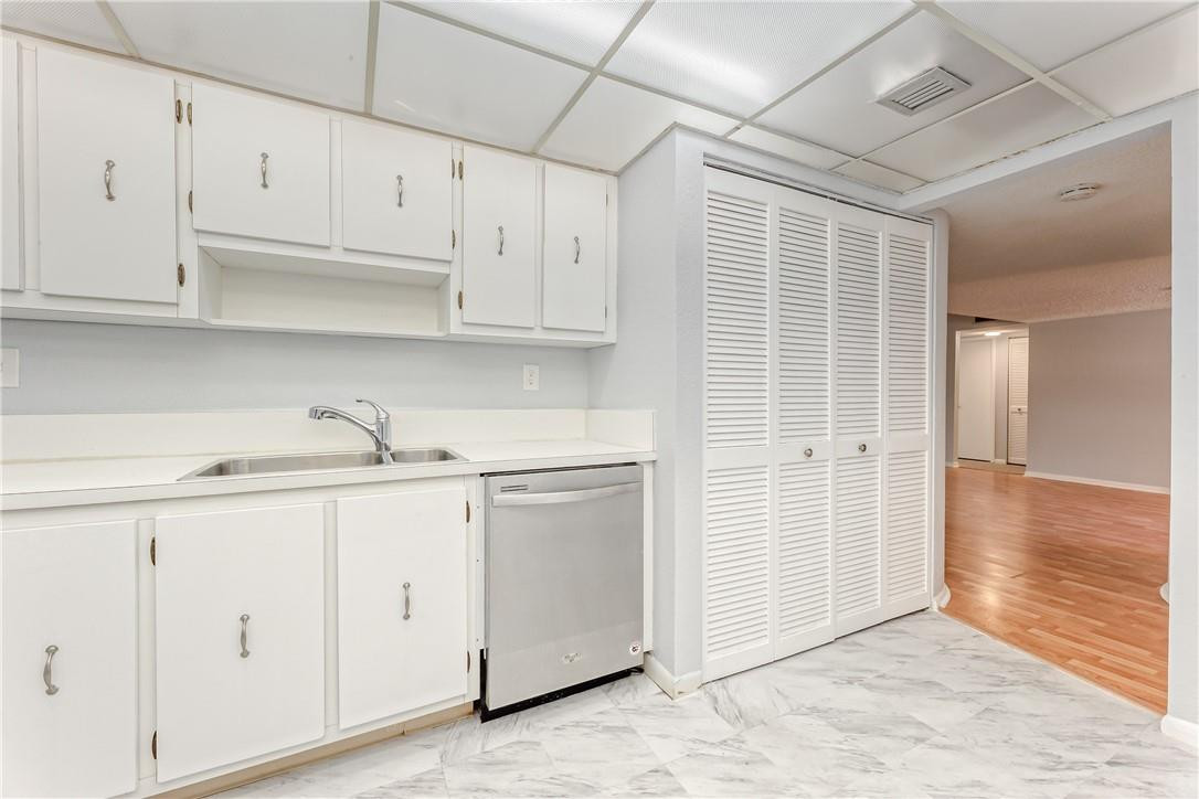 3900 Inverrary Boulevard, Unit E2 Lauderhill, FL 33319 - Photo 15 of 45 a kitchen with white cabinets and white appliances