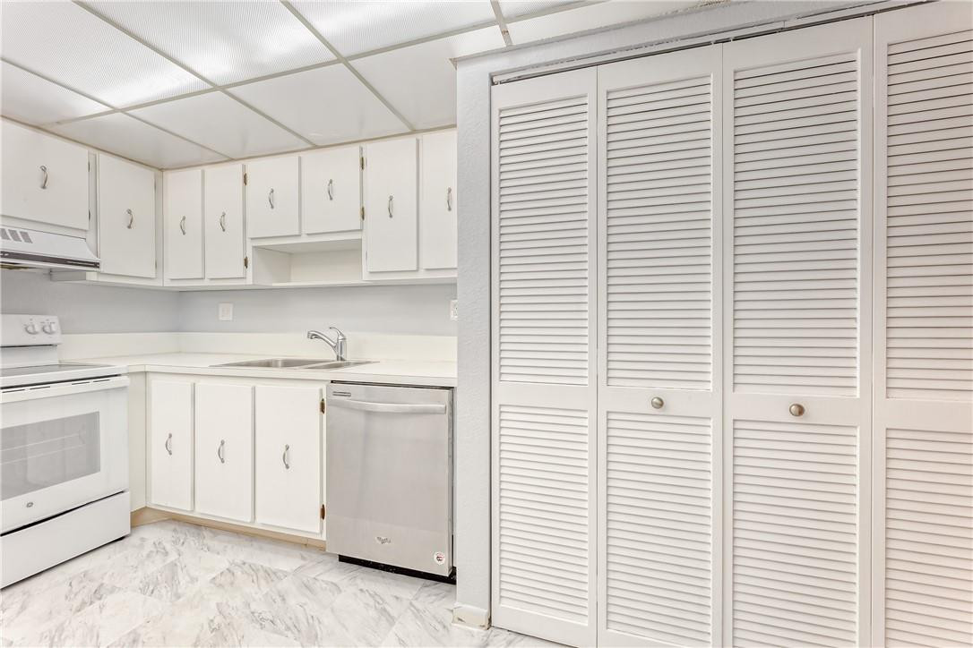 3900 Inverrary Boulevard, Unit E2 Lauderhill, FL 33319 - Photo 17 of 45 a kitchen with stainless steel appliances cabinets and a window