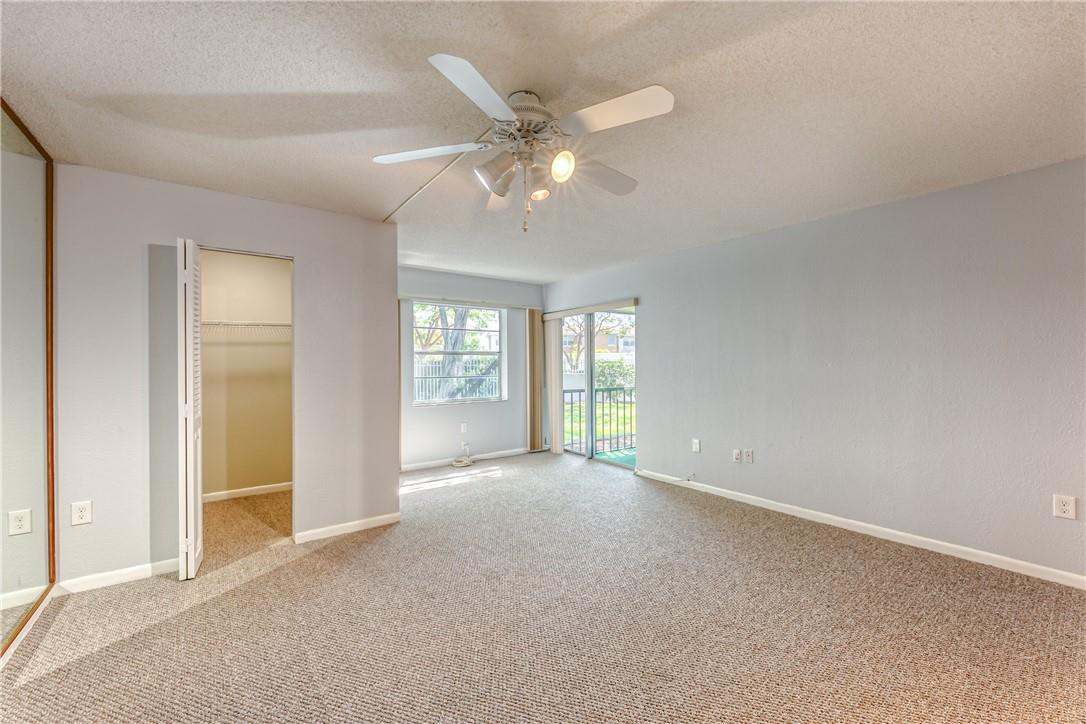 3900 Inverrary Boulevard, Unit E2 Lauderhill, FL 33319 - Photo 21 of 45 a view of an empty room with chandelier fan and a window
