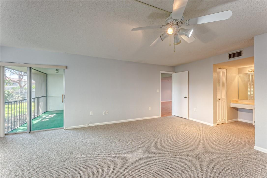3900 Inverrary Boulevard, Unit E2 Lauderhill, FL 33319 - Photo 23 of 45 an empty room with chandelier fan and windows