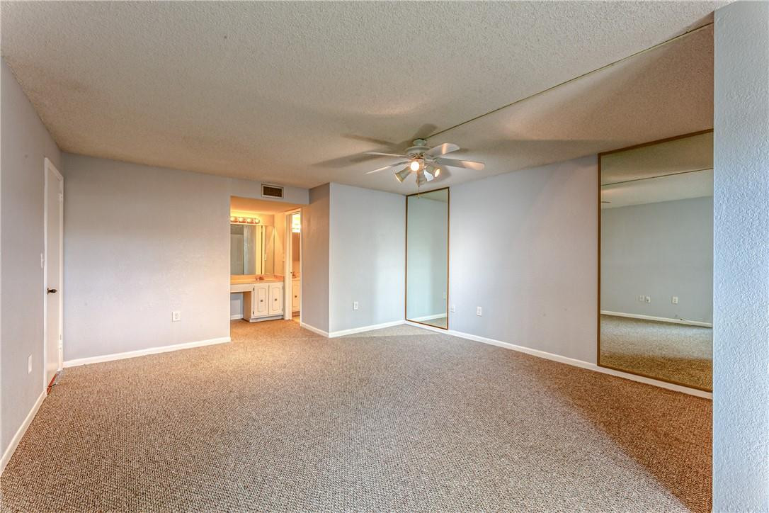 3900 Inverrary Boulevard, Unit E2 Lauderhill, FL 33319 - Photo 24 of 45 a view of an empty room with a chandelier fan