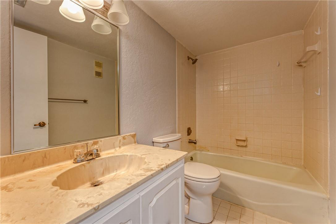 3900 Inverrary Boulevard, Unit E2 Lauderhill, FL 33319 - Photo 34 of 45 a bathroom with a granite countertop sink a toilet and shower