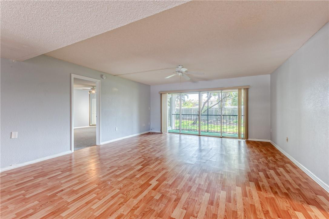 3900 Inverrary Boulevard, Unit E2 Lauderhill, FL 33319 - Photo 5 of 45 a view of an empty room with wooden floor and a window