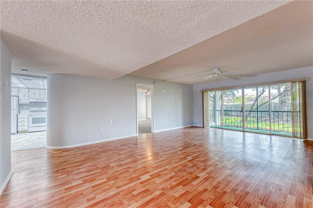 3900 Inverrary Boulevard, Unit E2 Lauderhill, FL 33319 - Photo 6 of 45 a view of an empty room with wooden floor and a window