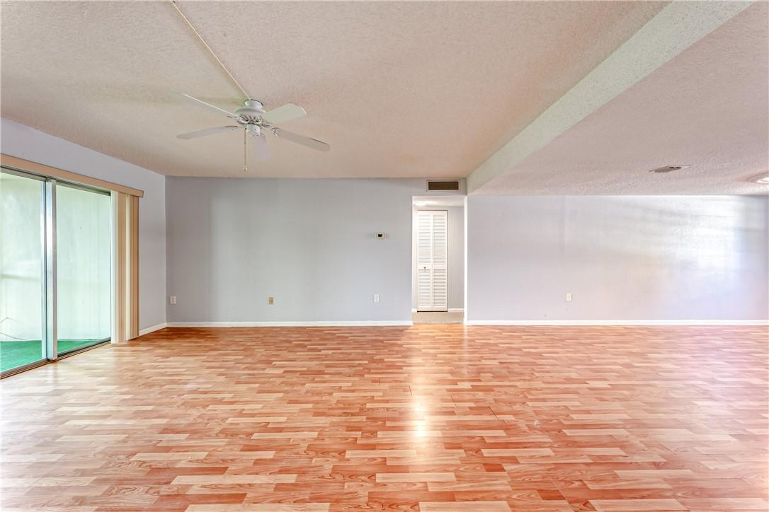 3900 Inverrary Boulevard, Unit E2 Lauderhill, FL 33319 - Photo 7 of 45 a view of an empty room with wooden floor and a window