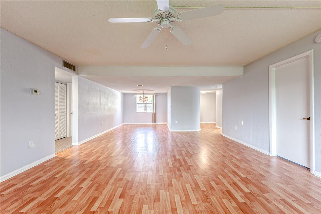 3900 Inverrary Boulevard, Unit E2 Lauderhill, FL 33319 - Photo 10 of 45 wooden floor in an empty room with a window