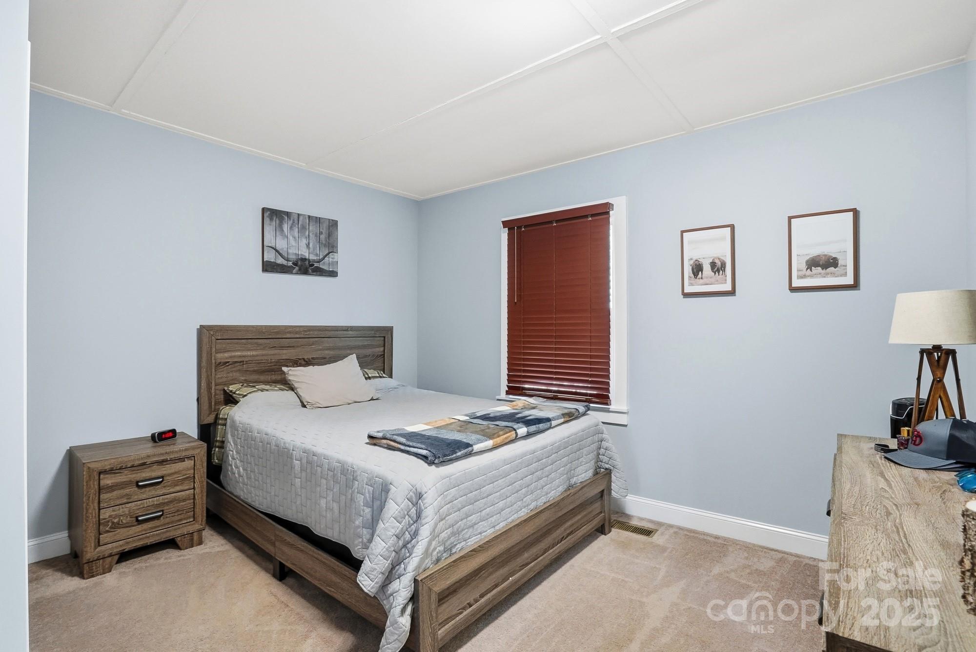 910 Roosevelt Street Badin, NC 28001 - Photo 12 of 30 a bedroom with a bed and a dresser in it