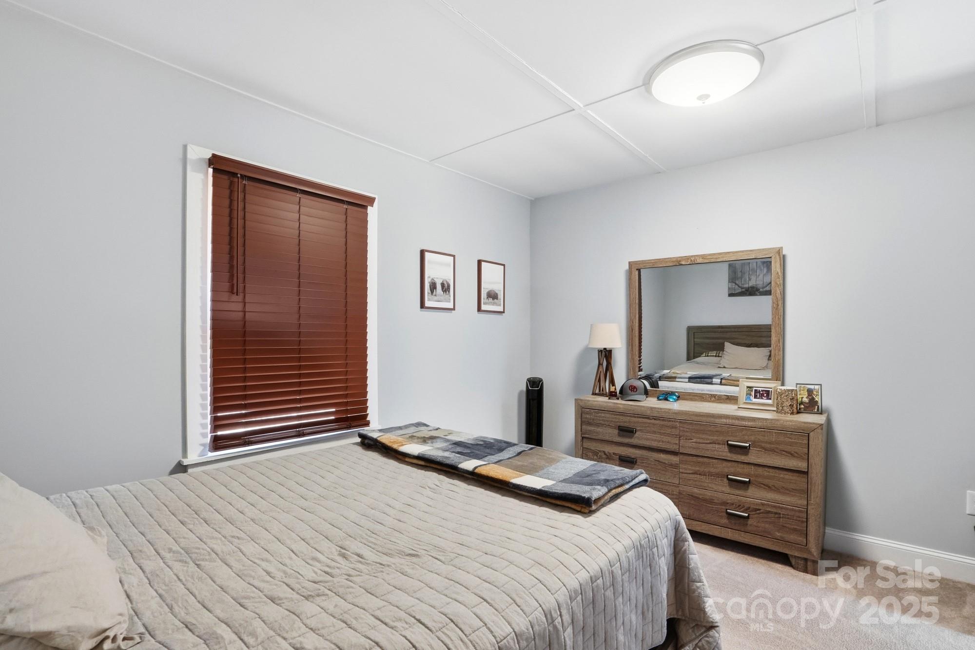 910 Roosevelt Street Badin, NC 28001 - Photo 13 of 30 a bedroom with a bed and a dresser