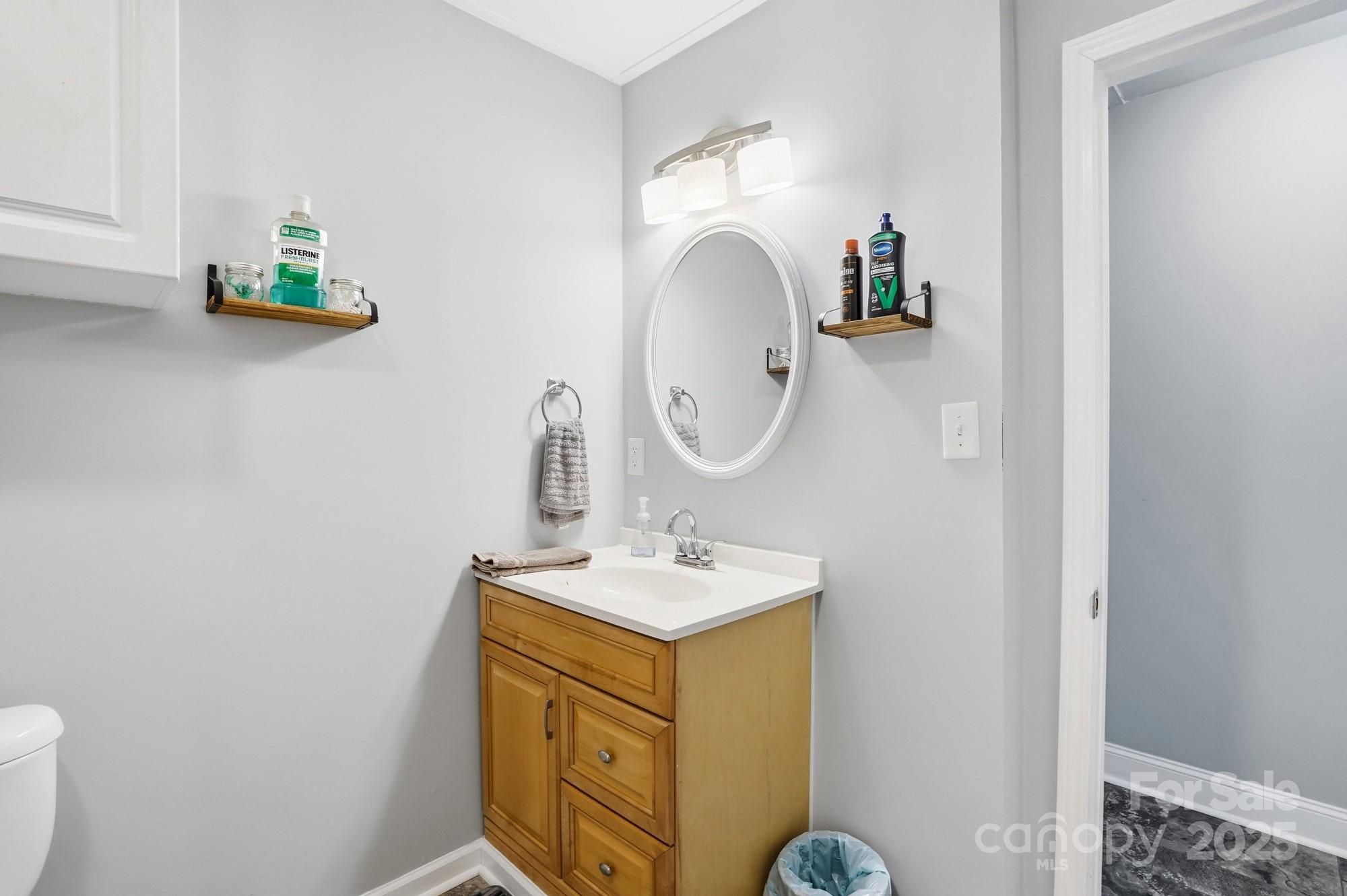 910 Roosevelt Street Badin, NC 28001 - Photo 15 of 30 a bathroom with a sink mirror and vanity