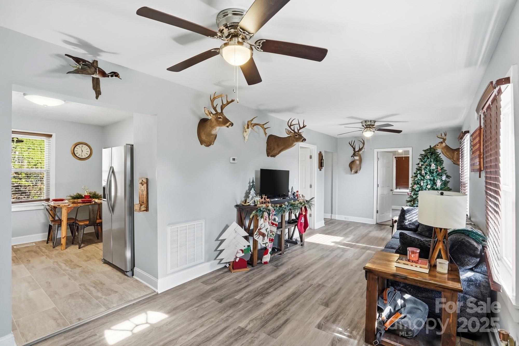 910 Roosevelt Street Badin, NC 28001 - Photo 9 of 30 a view of a livingroom with furniture a ceiling fan and wooden floor