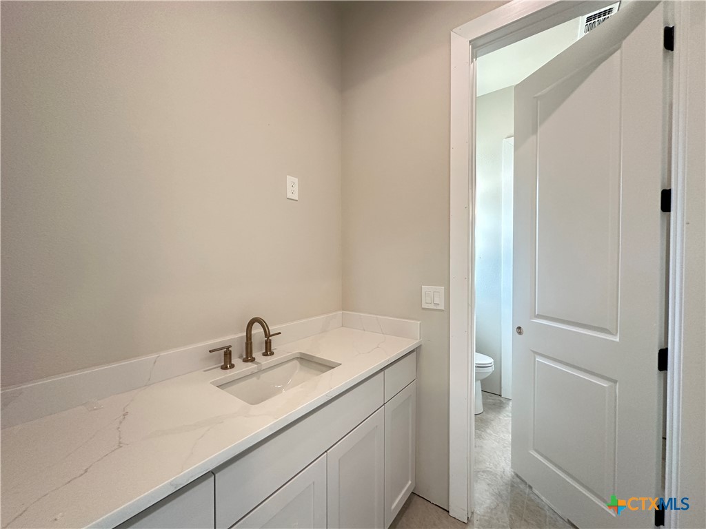 418 Dos Rios Drive Belton, TX 76513 - Photo 16 of 41 a bathroom with a sink toilet and vanity