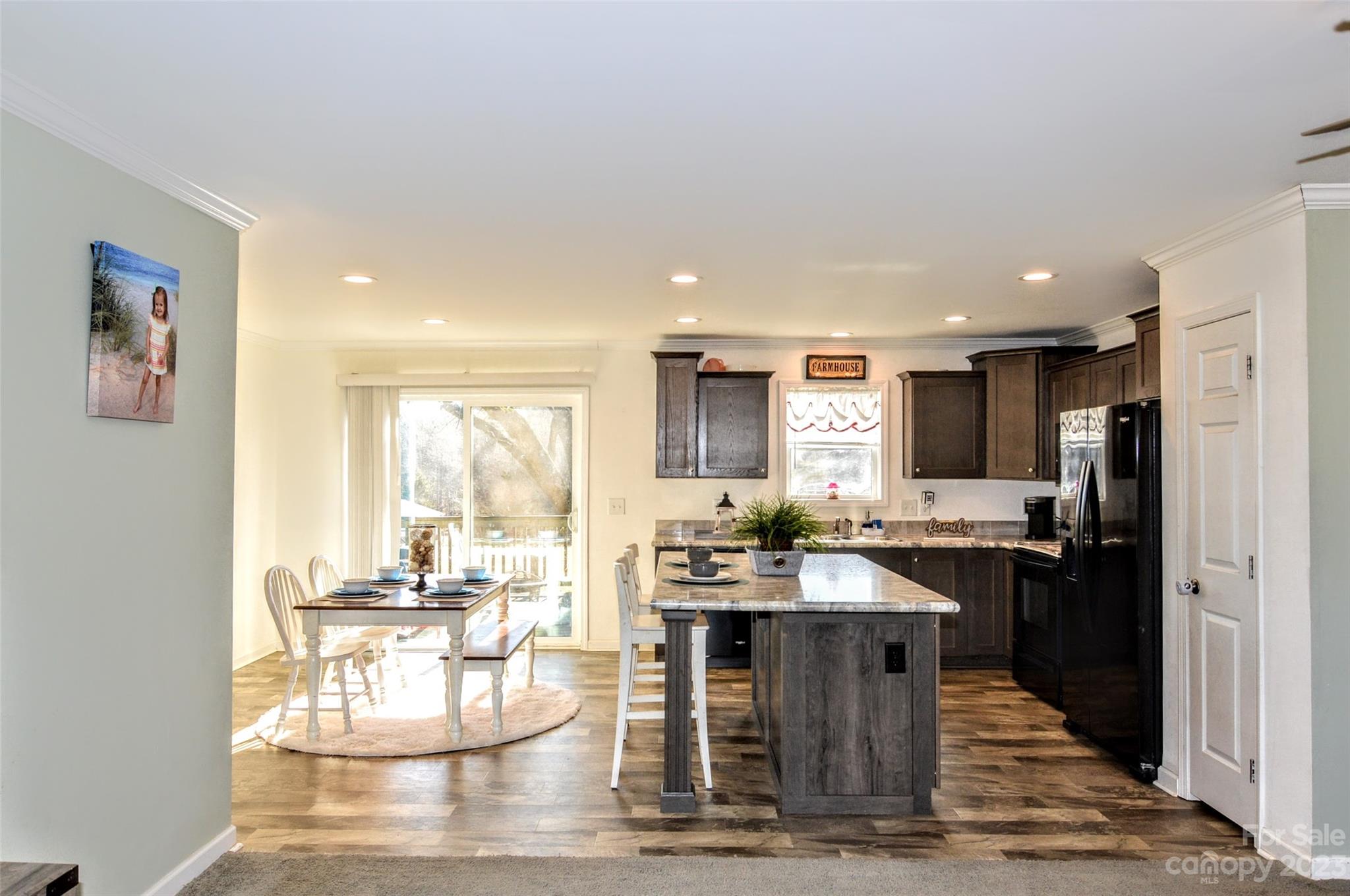 5717 Griffith Road Monroe, NC 28112 - Photo 15 of 48 a kitchen with stainless steel appliances kitchen island granite countertop a refrigerator and stove