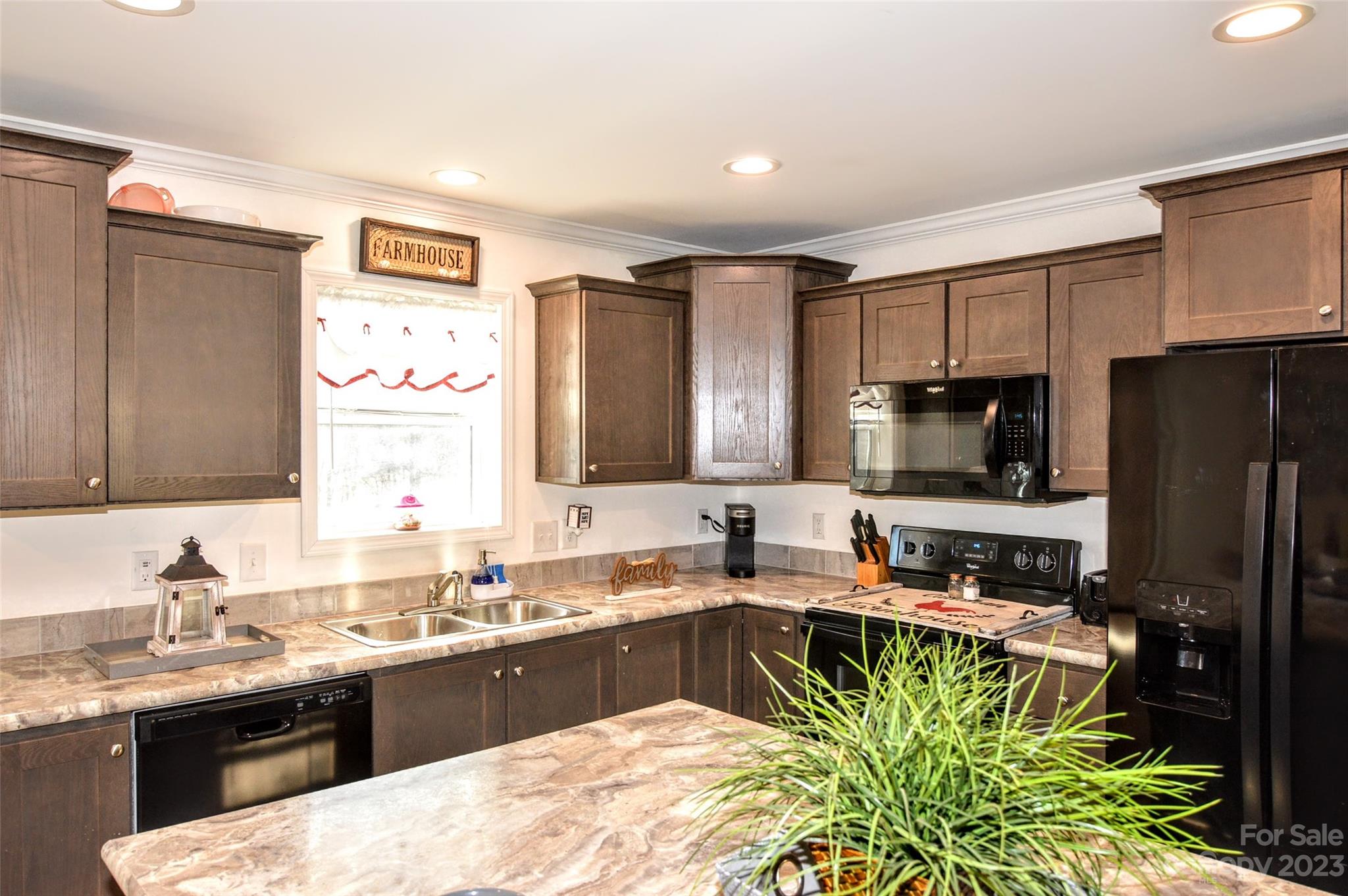 5717 Griffith Road Monroe, NC 28112 - Photo 16 of 48 a kitchen with a sink stove and refrigerator