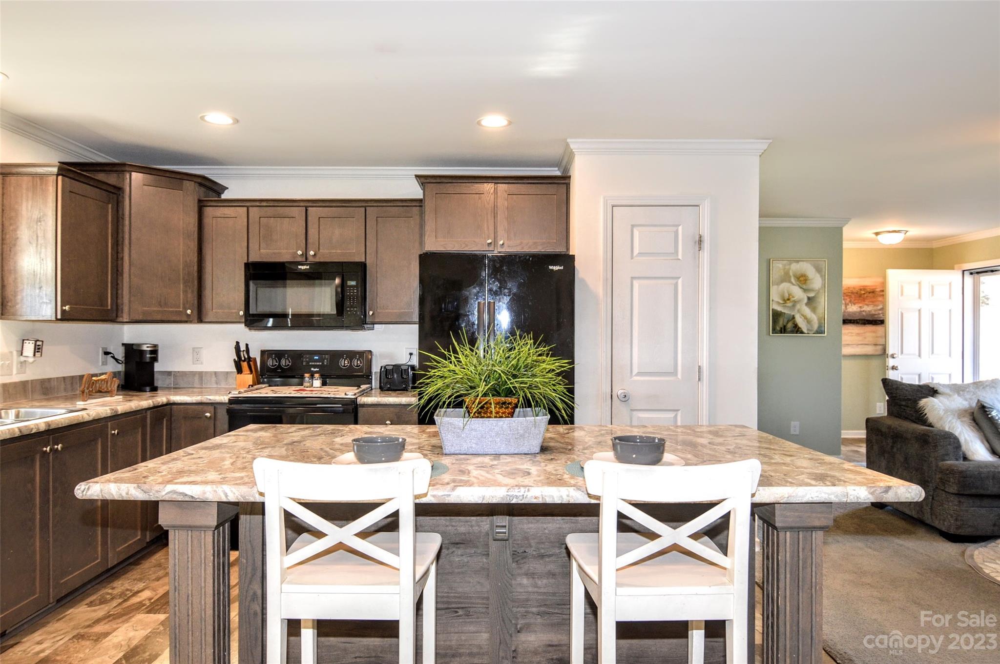 5717 Griffith Road Monroe, NC 28112 - Photo 17 of 48 a kitchen with a table chairs refrigerator and microwave