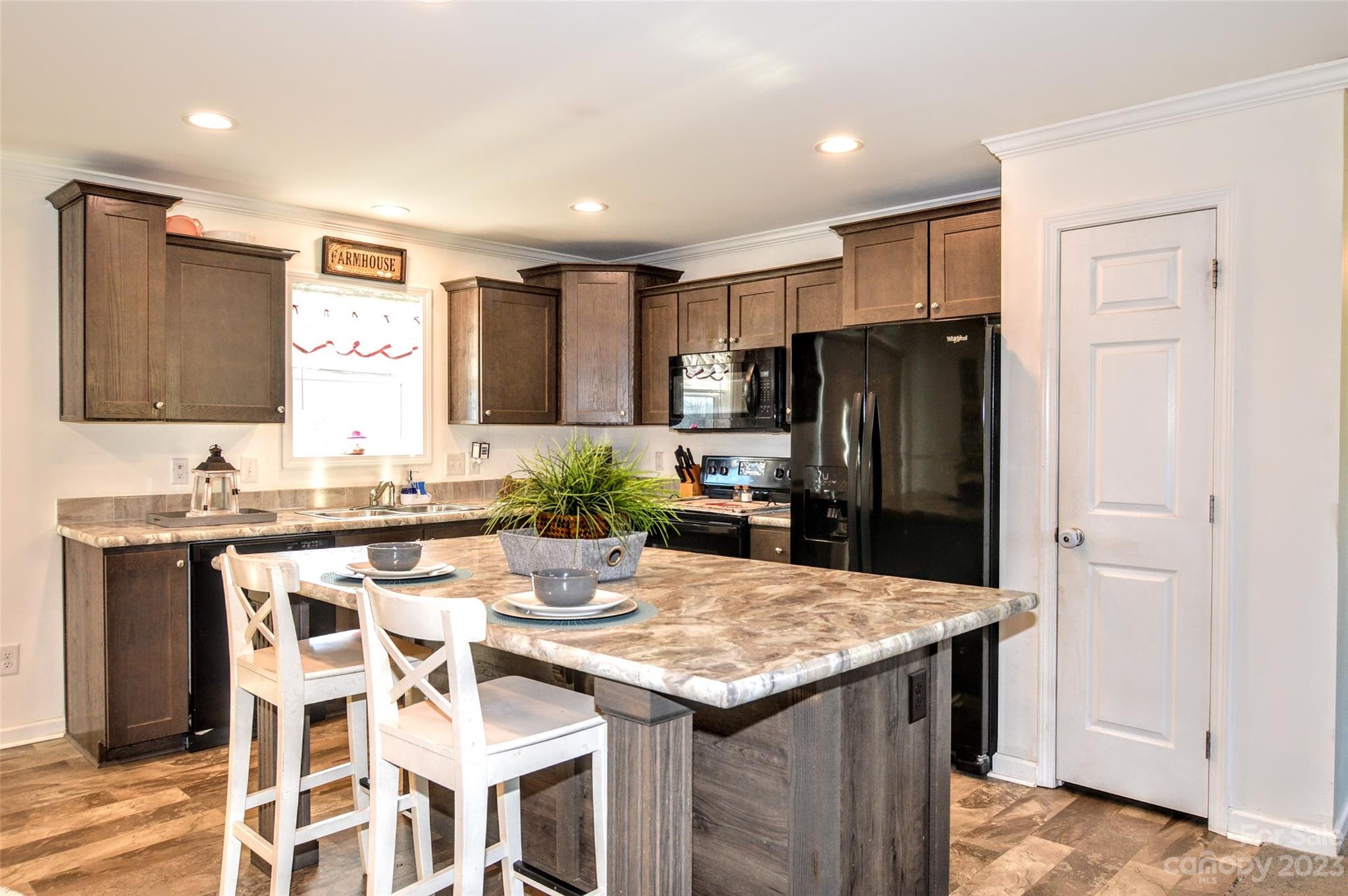 5717 Griffith Road Monroe, NC 28112 - Photo 18 of 48 a kitchen with a refrigerator and a stove top oven