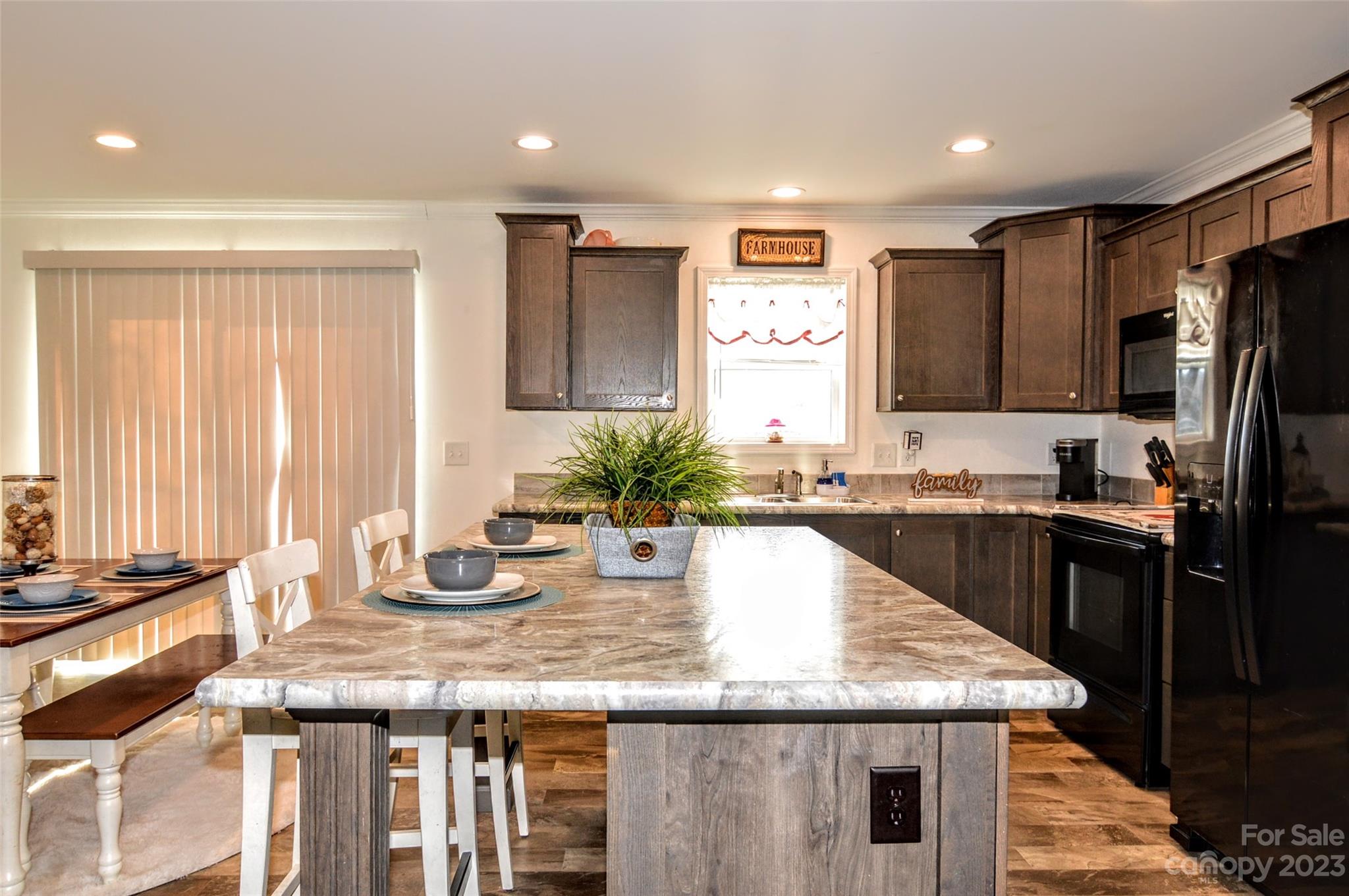 5717 Griffith Road Monroe, NC 28112 - Photo 19 of 48 a kitchen with granite countertop kitchen island a counter space and stainless steel appliances