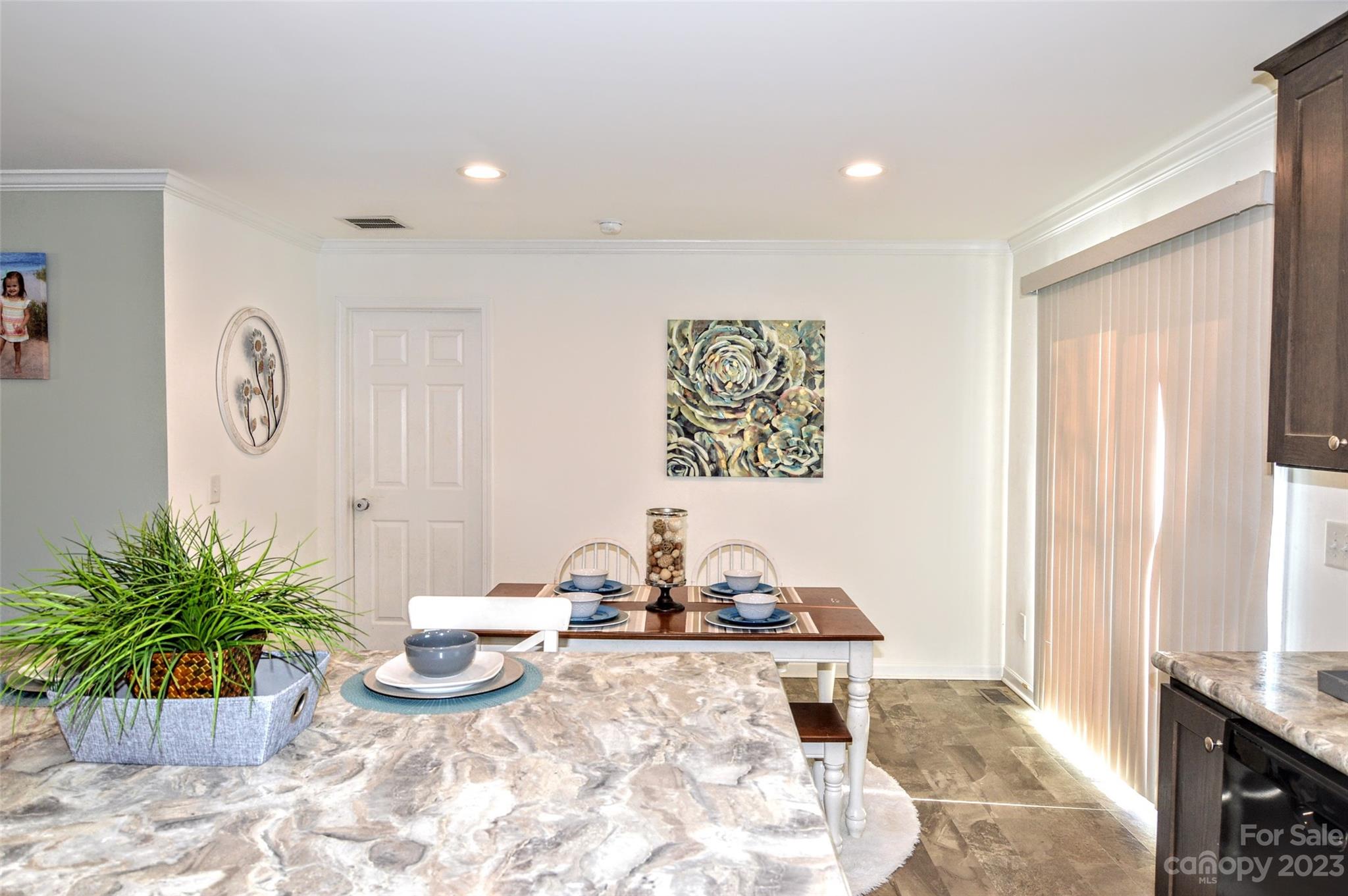 5717 Griffith Road Monroe, NC 28112 - Photo 20 of 48 a view of a dining room with furniture and a potted plant