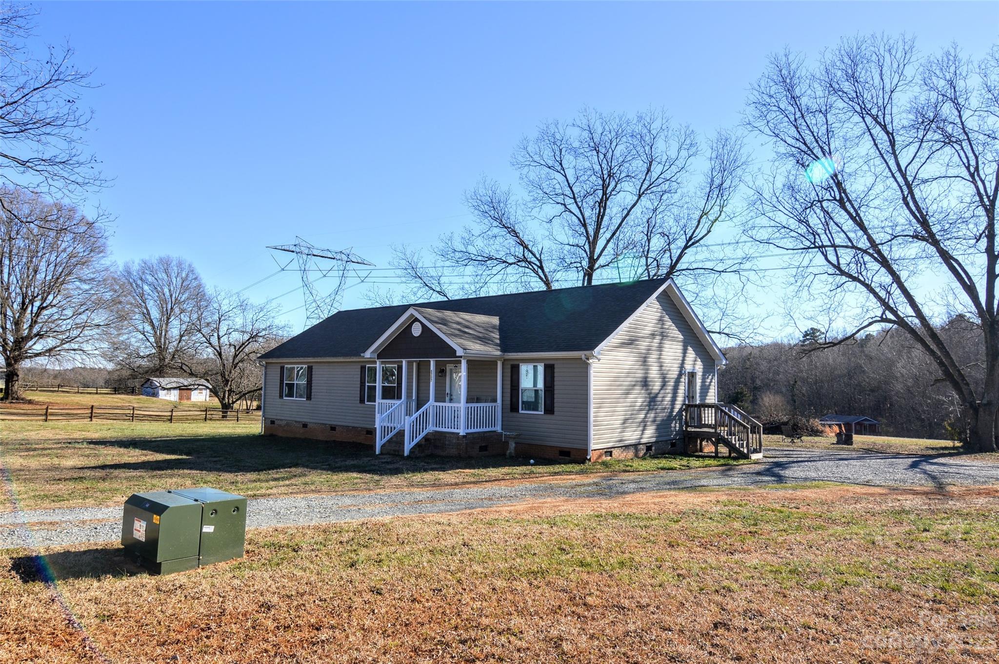 5717 Griffith Road Monroe, NC 28112 - Photo 2 of 48 a view of a house with snow on the side of a road