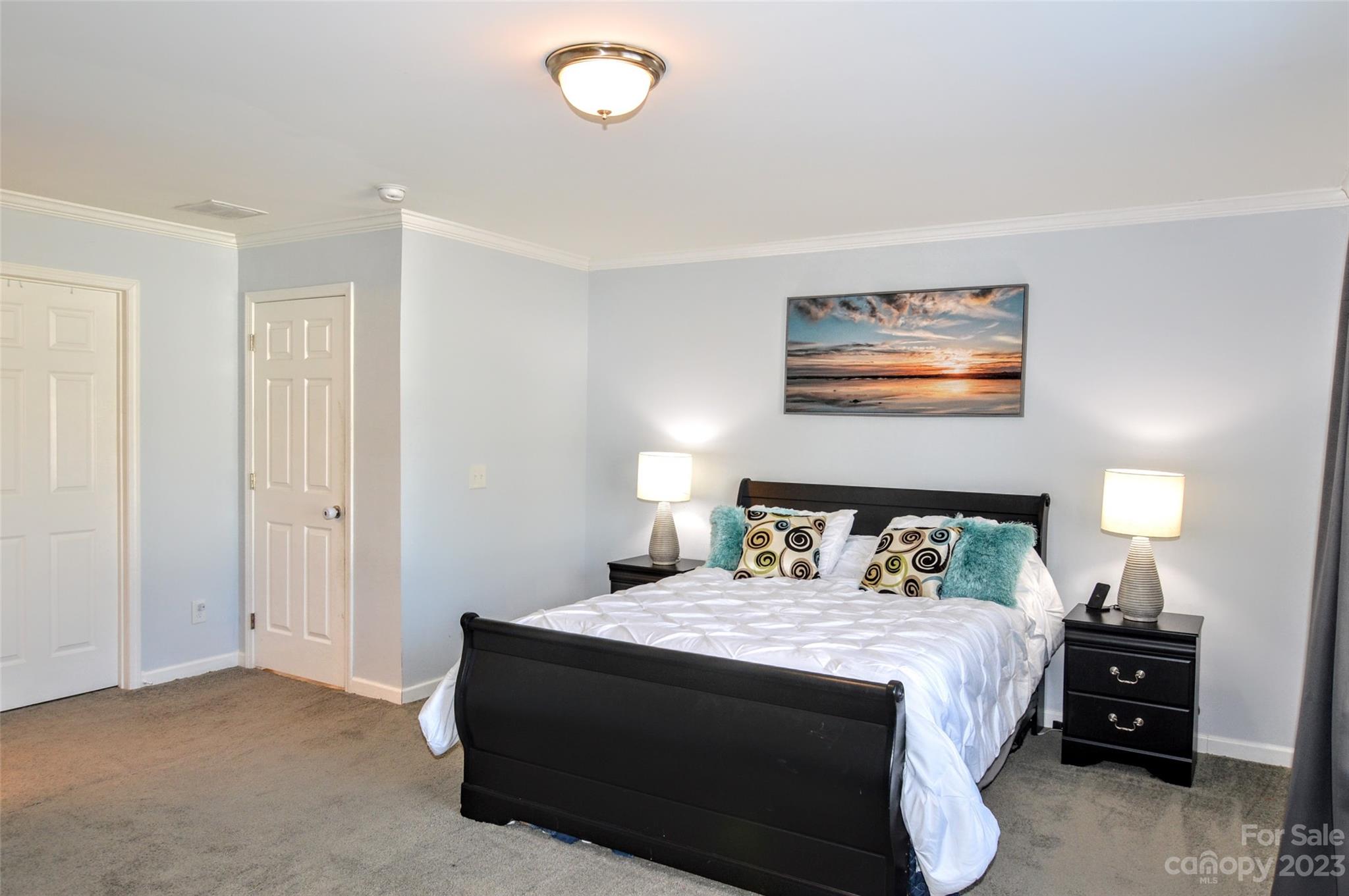 5717 Griffith Road Monroe, NC 28112 - Photo 24 of 48 a bedroom with a bed and wall painting