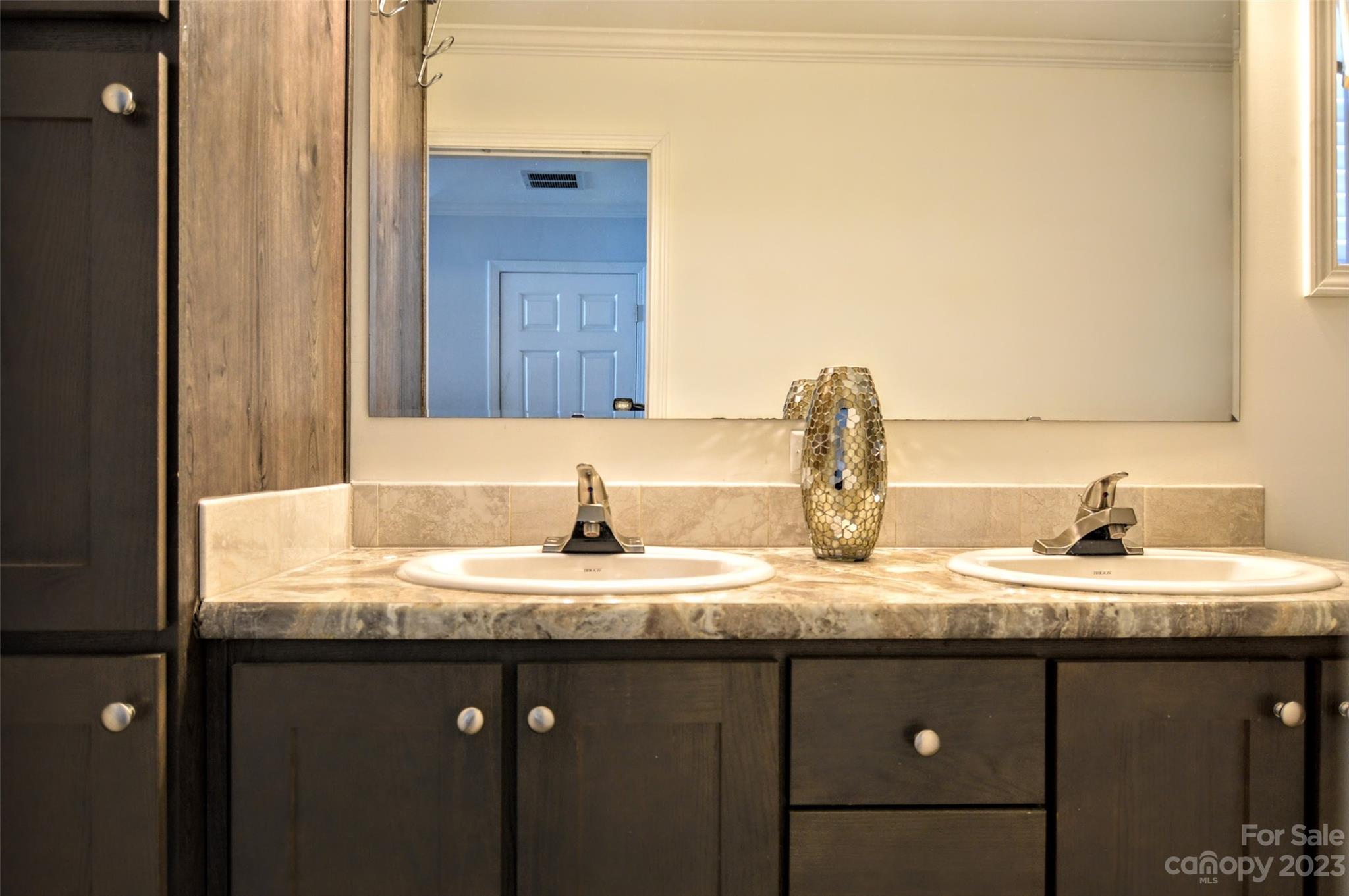 5717 Griffith Road Monroe, NC 28112 - Photo 27 of 48 a bathroom with a granite countertop sink and a mirror