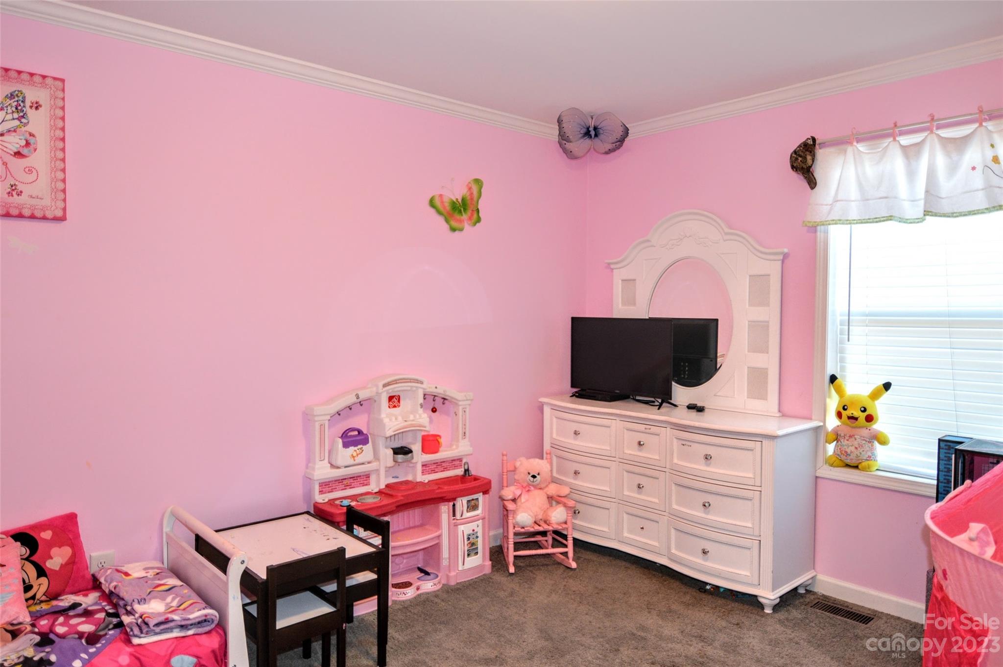 5717 Griffith Road Monroe, NC 28112 - Photo 32 of 48 a bedroom with a bed and a flat screen tv