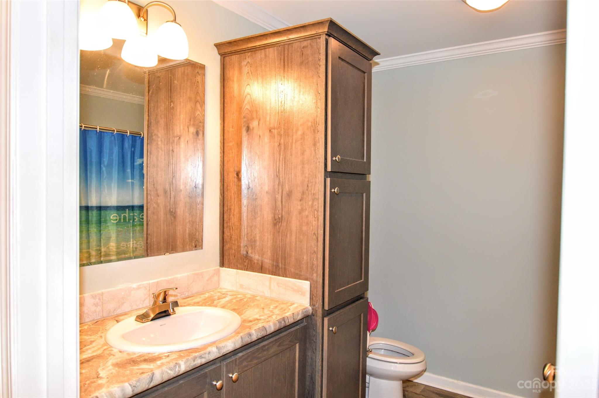 5717 Griffith Road Monroe, NC 28112 - Photo 34 of 48 a bathroom with a granite countertop sink toilet and shower
