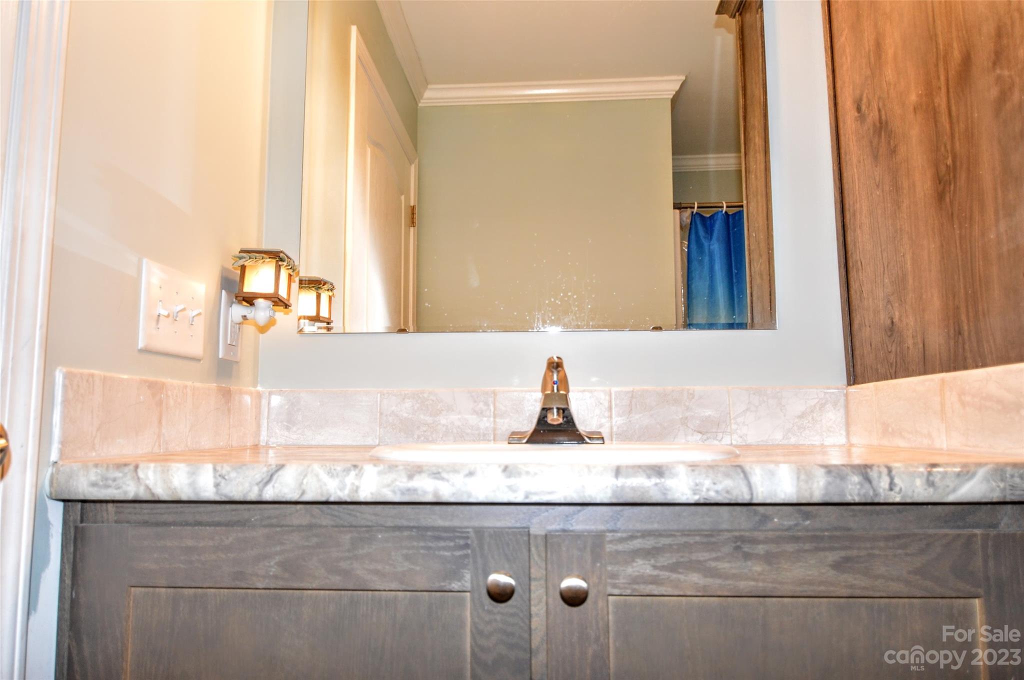 5717 Griffith Road Monroe, NC 28112 - Photo 37 of 48 a bathroom with a granite countertop sink and a mirror
