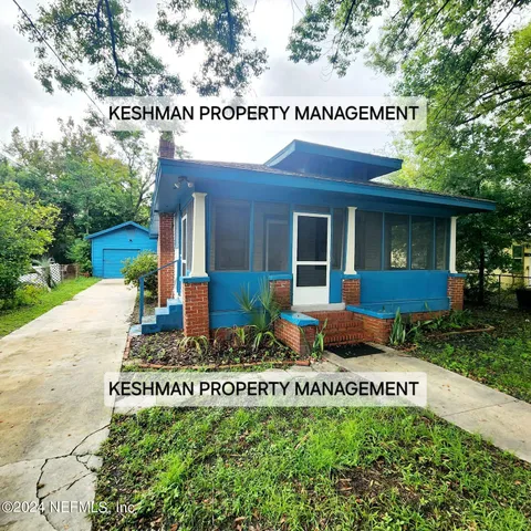 a view of a house with a yard and table and chairs