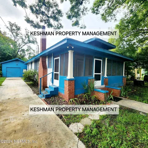 a front view of house with sign board and yard