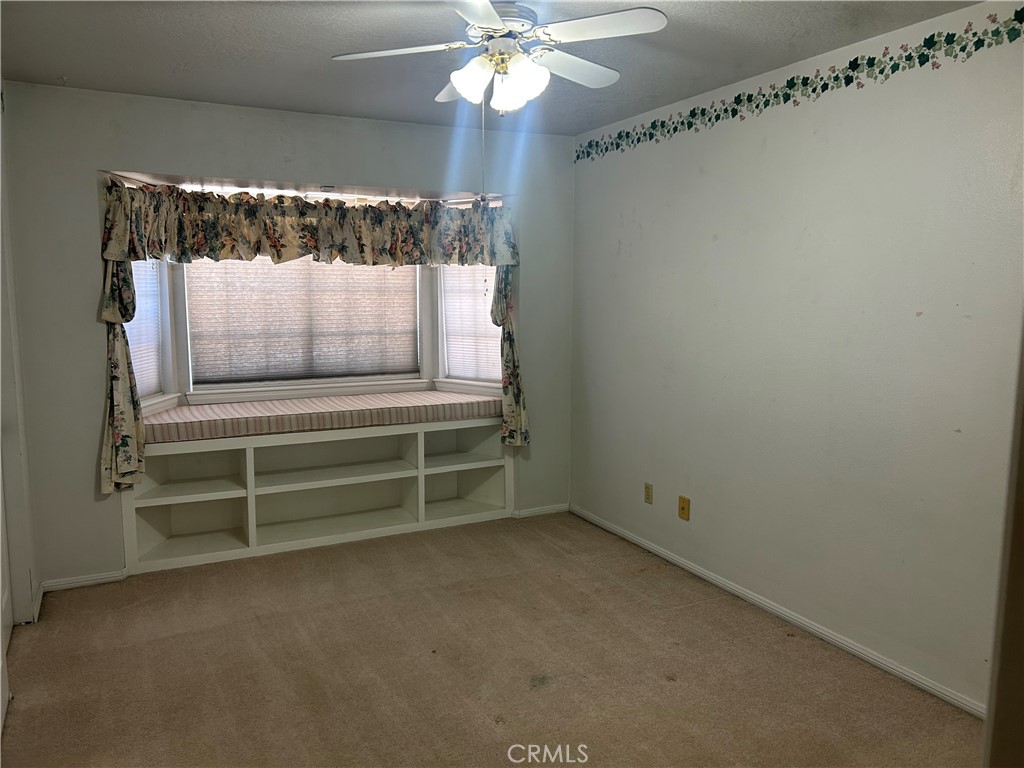 20187 Itasca Road Apple Valley, CA 92308 - Photo 11 of 35 a view of room with a ceiling fan and wooden floor