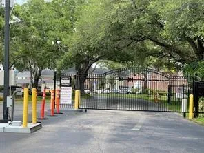 a view of a park with iron fence