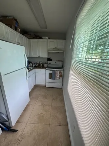 a kitchen with a refrigerator and a stove