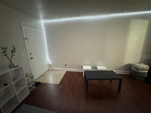 a view of a workspace with furniture and wooden floor