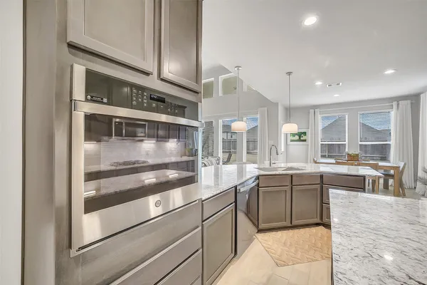 a kitchen with counter top space and stainless steel appliances