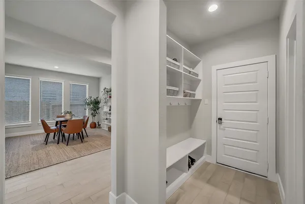 a bedroom with a bed a couch and a flat tv screen on dresser