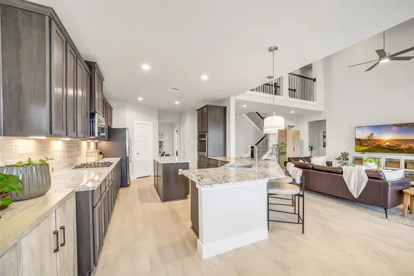 a kitchen with stainless steel appliances kitchen island granite countertop a sink and cabinets
