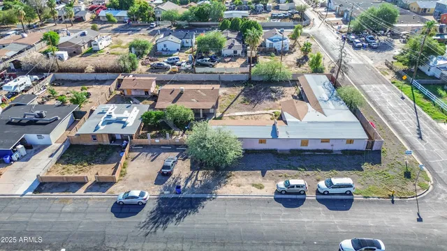 an aerial view of a house with garden space and a patio