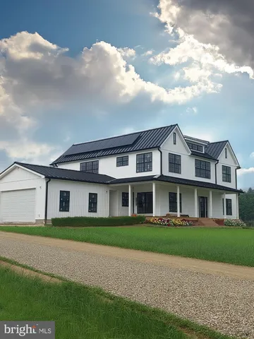 a view of a grassy field with trees in the background