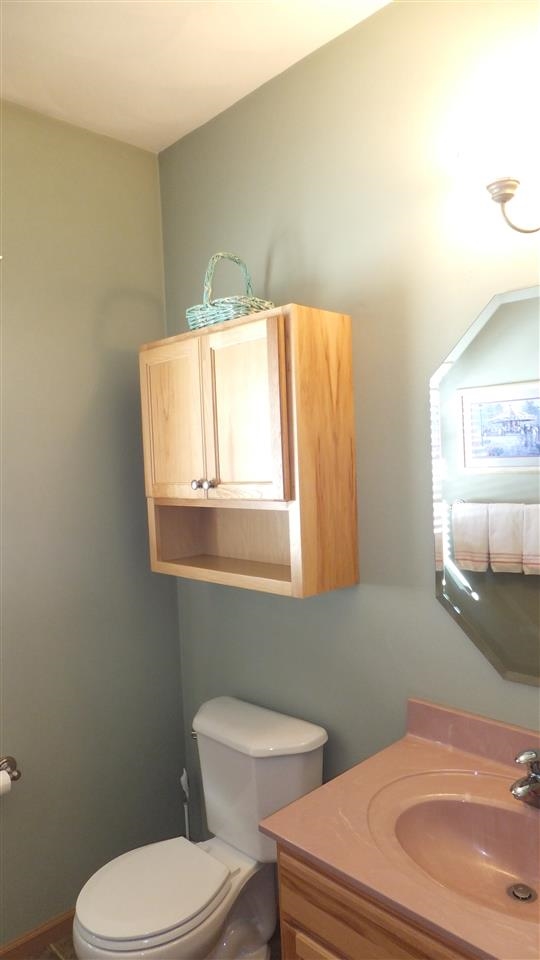 2835 Dourdan Road Belvidere, IL 61008 - Photo 11 of 25 a bathroom with a toilet sink and mirror