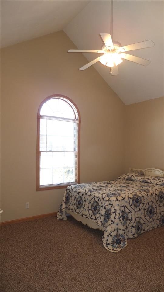 2835 Dourdan Road Belvidere, IL 61008 - Photo 15 of 25 a bedroom with a bed and a chandelier