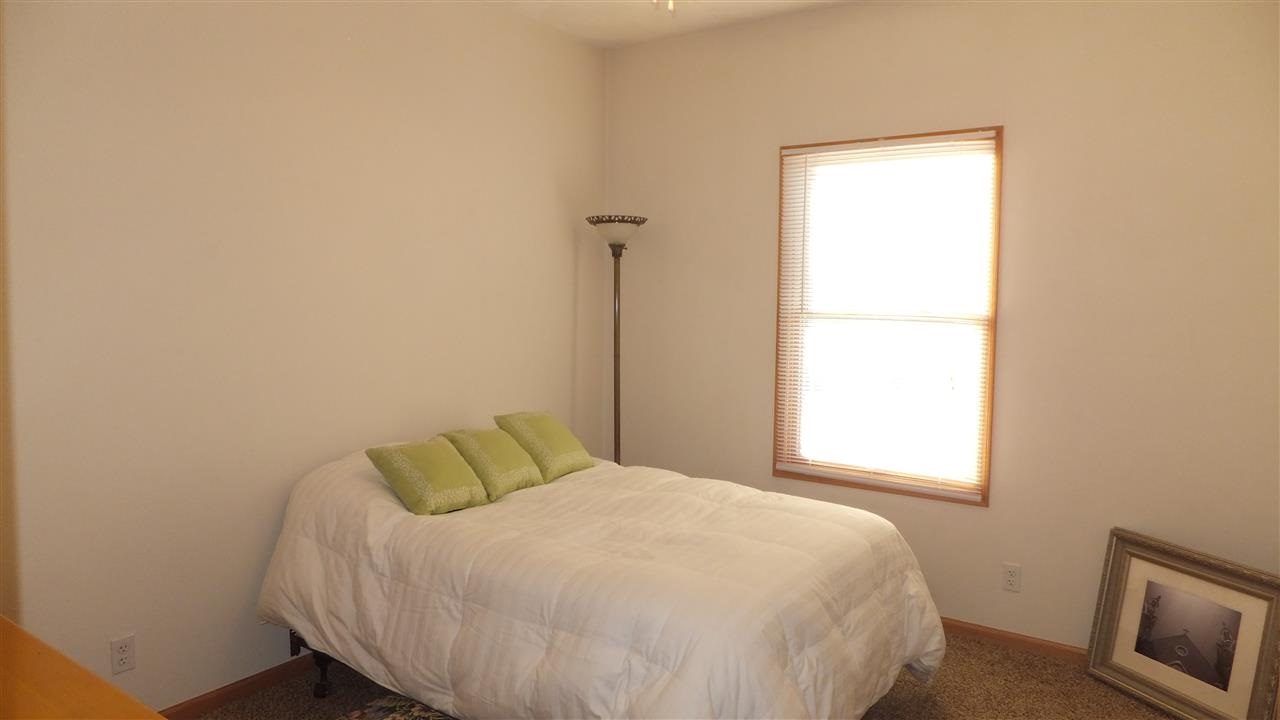 2835 Dourdan Road Belvidere, IL 61008 - Photo 17 of 25 a bedroom with a bed and a window
